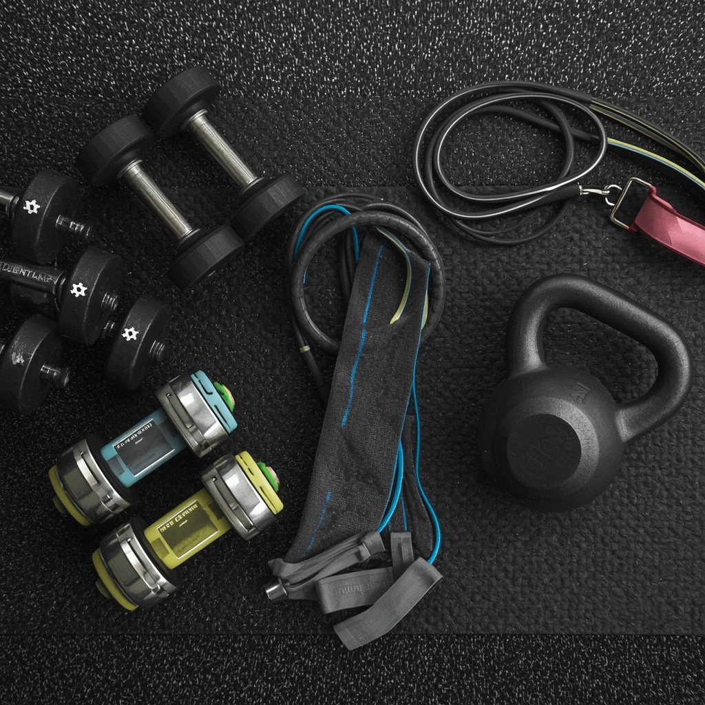 A gym setup with dumbbells, resistance bands, and a kettlebell on a mat, no woman in the image, generated via Nano Banana2